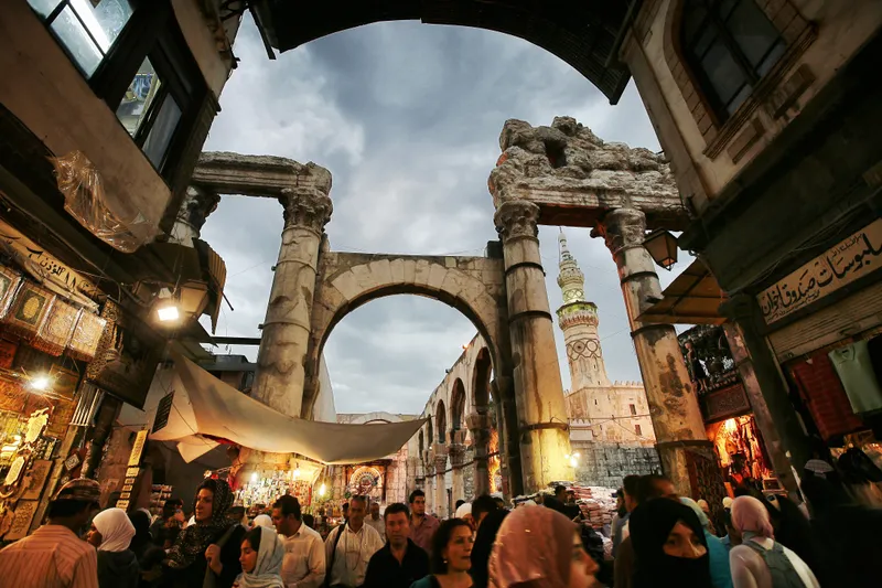 Damascus crowded market area with Roman ruins