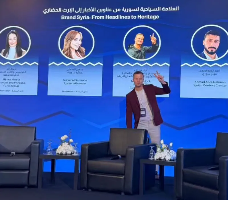 Nick Maddock on stage before a panel at the 2026 Syria Travel Show in Damascus