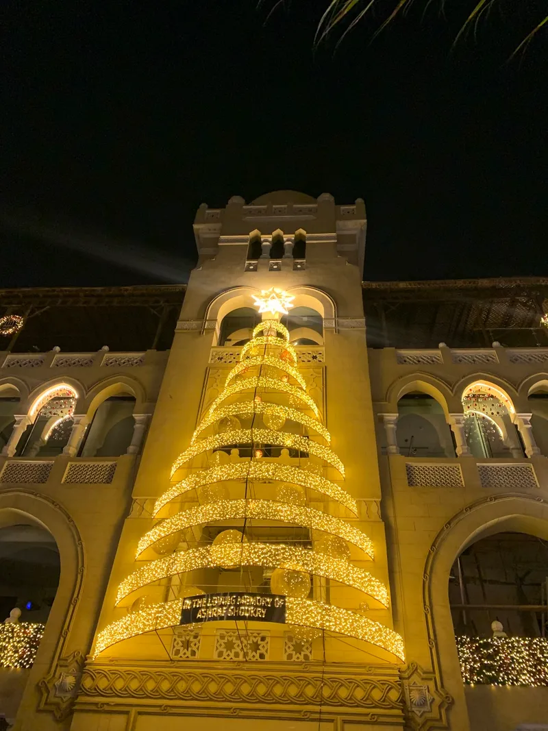 A Christmas tree in front of an Islamic building in Cairo